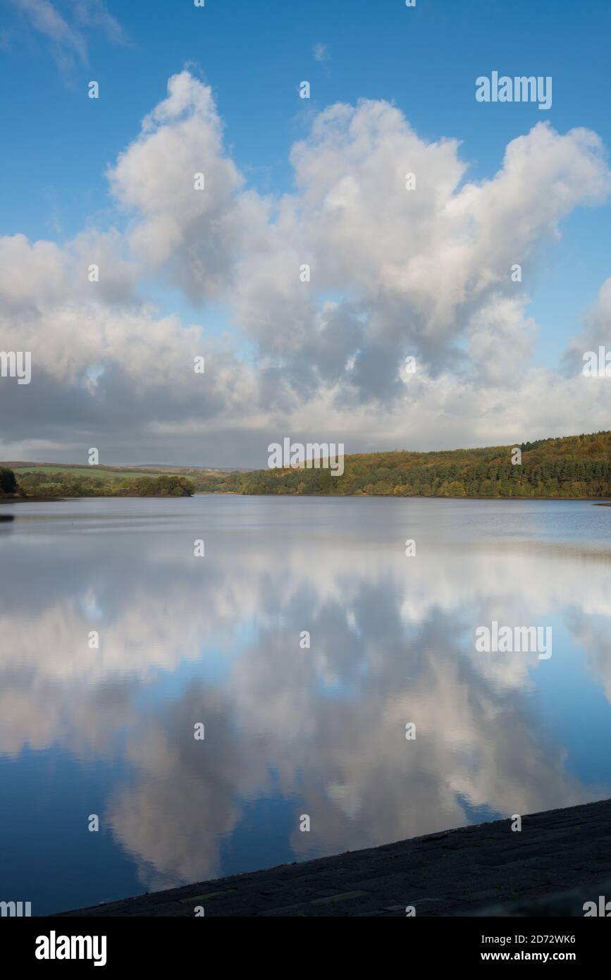 Cumulus clouds reflected in the still waters of Fewston reservoir in the Washburn Valley, North Yorkshire Stock Photo