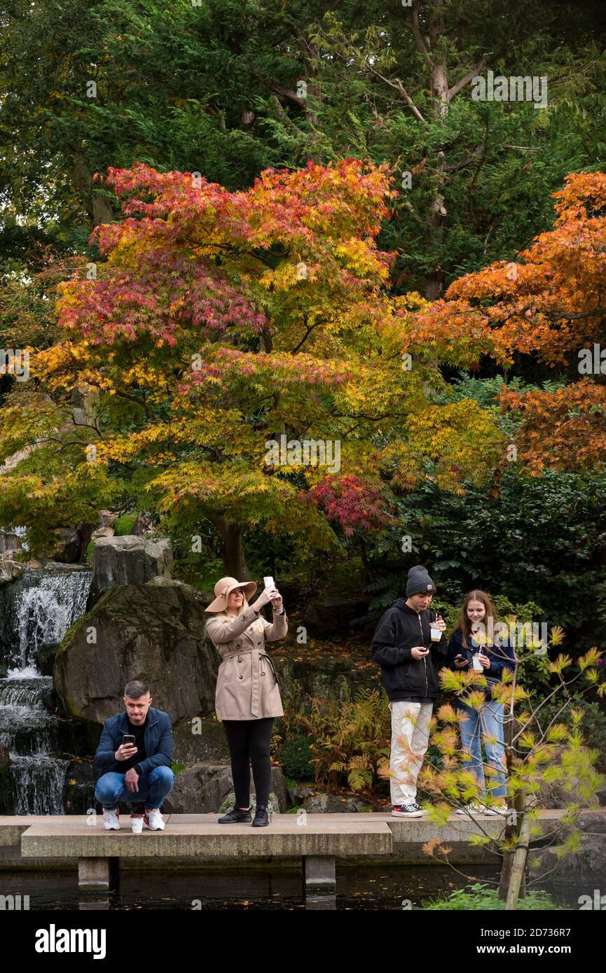 London, UK.  20 October 2020. UK Weather - Visitors enjoy the autumnal display of changing leaves in the Japanese themed Kyoto Garden in Holland Park. The forecast is for a heavy rain to arrive in the next few days across much of the UK.  Credit: Stephen Chung / Alamy Live News Stock Photo