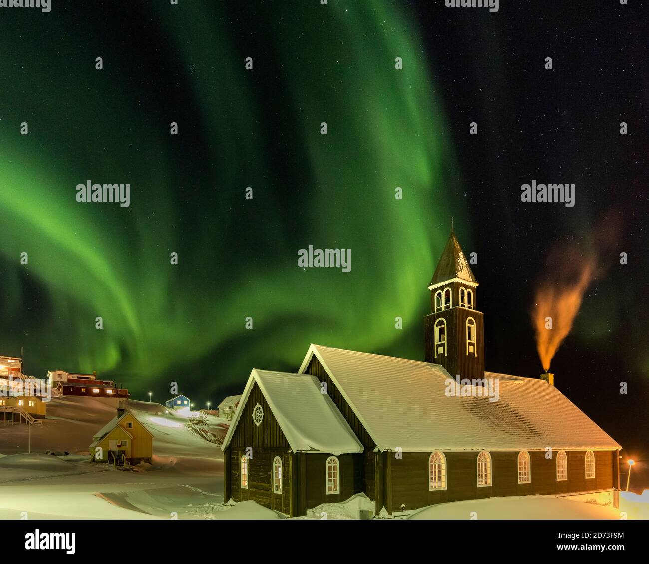 Northern Lights over the Zion s Church. Town Ilulissat at the shore of Disko Bay in West Greenland, center for tourism, administration and economy. Th Stock Photo