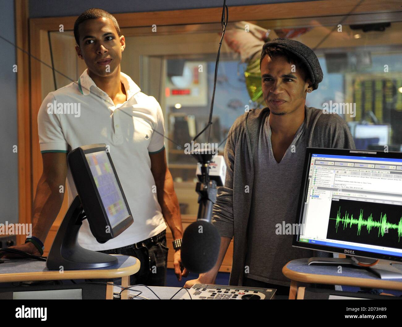 (L-R) Marvin Humes and Aston Merrygold JLS are interviewed by Johnny Vaughn and Lisa Snowdon on the Capital Radio breakfast show, at the Global Radio studios in central London Stock Photo
