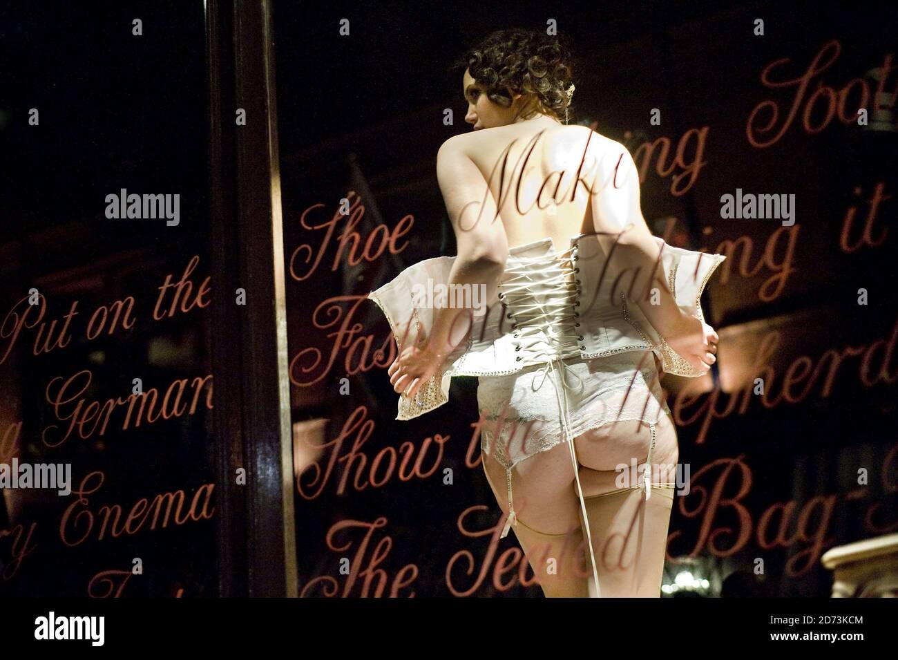Burlesque dancers perform live in the window of Coco de Mer in Covent
