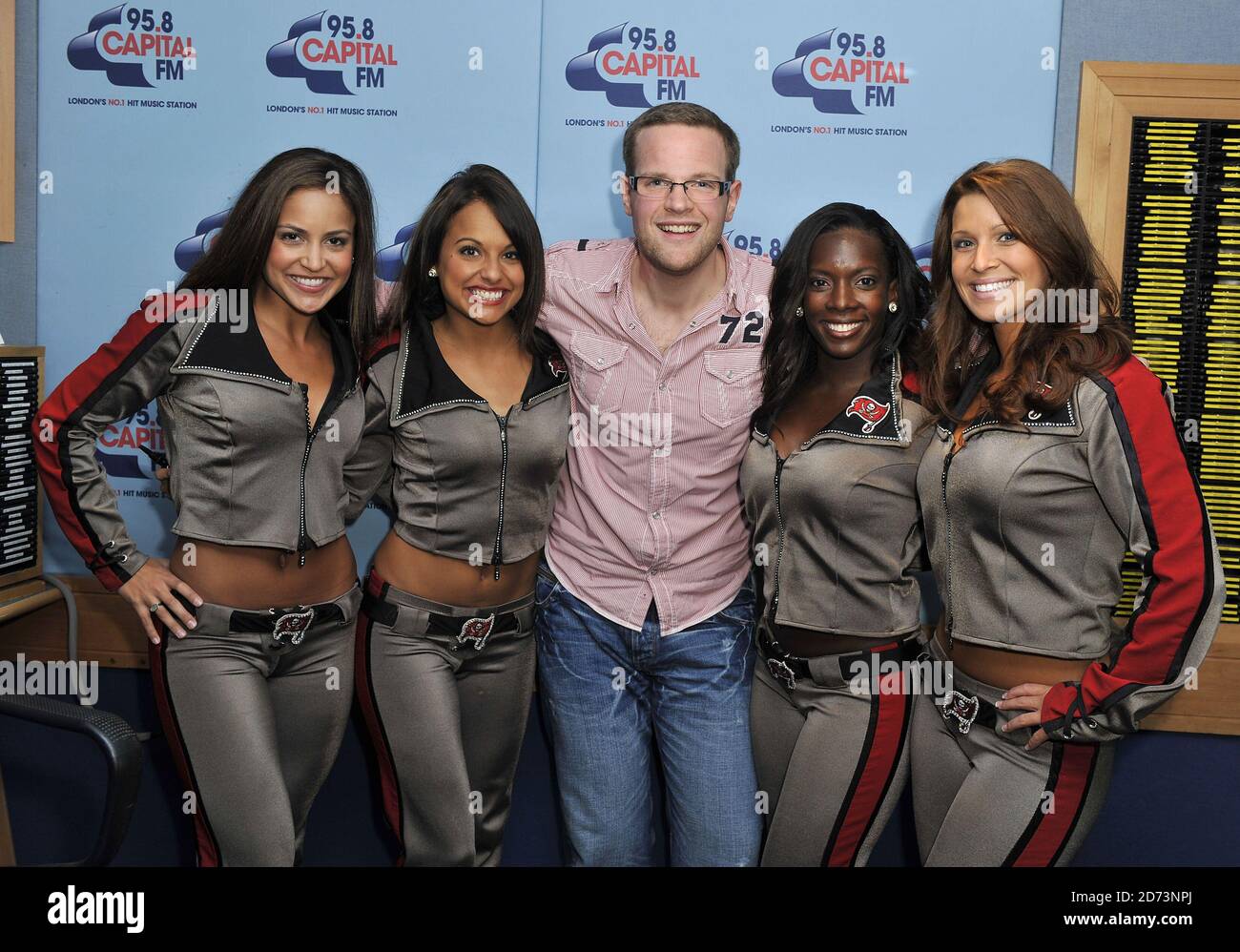 (l-r) Corinne Colon, Tiffany Jimenez, DJ Roberto, Kelli Jones and Jaime Hanna of the Tampa Bay Cheerleaders pose for photographs at the Global Radio studios in central London, after appearing on the Roberto radio show on 95.8 Capital FM.  Stock Photo