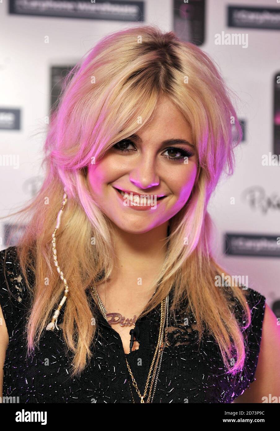 Pixie Lott poses for photographs at the Carphone Warehouse in Central London to mark the launch of the Illuvial Pink collection of handsets from Nokia. Stock Photo