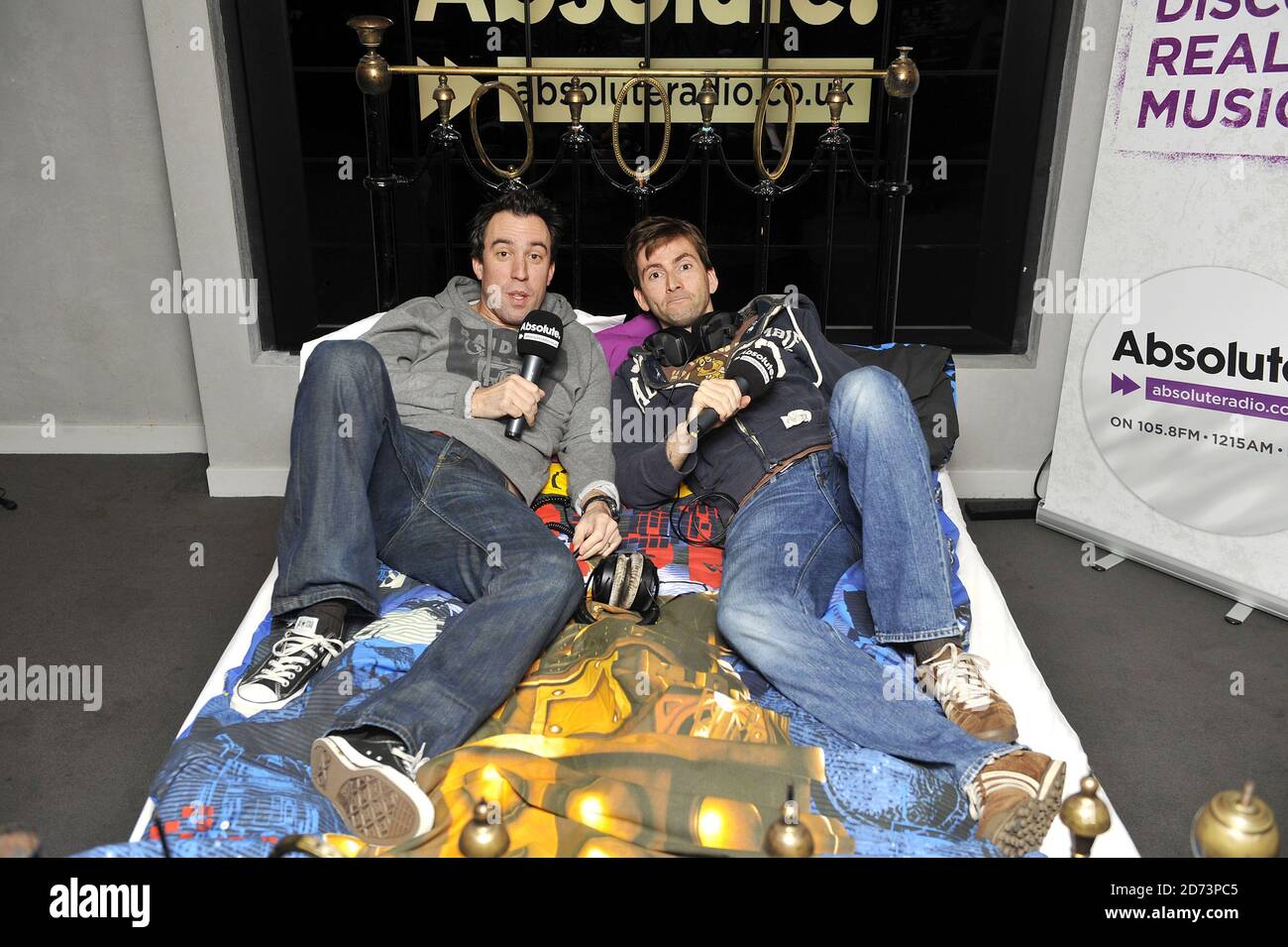 David Tennant and Christian O'Connell broadcast from David Tennant's bed during O'Connell's breakfast show. The bed will be auctioned tomorrow with proceeds going to Children in Need. Stock Photo