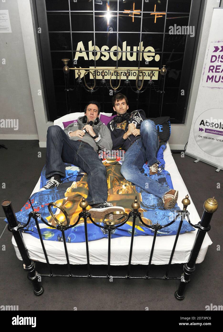 David Tennant and Christian O'Connell broadcast from David Tennant's bed during O'Connell's breakfast show. The bed will be auctioned tomorrow with proceeds going to Children in Need. Stock Photo