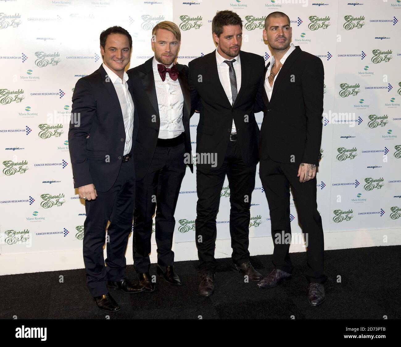 (l-r) Mikey Graham, Ronan Keating, Keith Duffy and Shane Lynch of Boyzone arrive at the Emeralds and Ivy Ball in aid of Cancer Research UK held at Battersea Evolution in south London Stock Photo