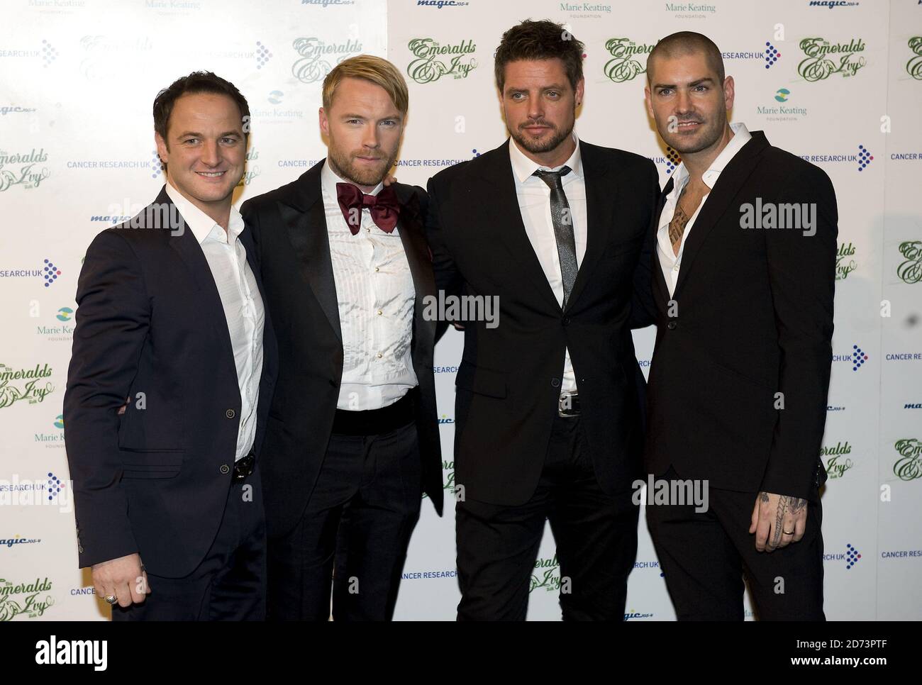 (l-r) Mikey Graham, Ronan Keating, Keith Duffy and Shane Lynch of Boyzone arrive at the Emeralds and Ivy Ball in aid of Cancer Research UK held at Battersea Evolution in south London Stock Photo