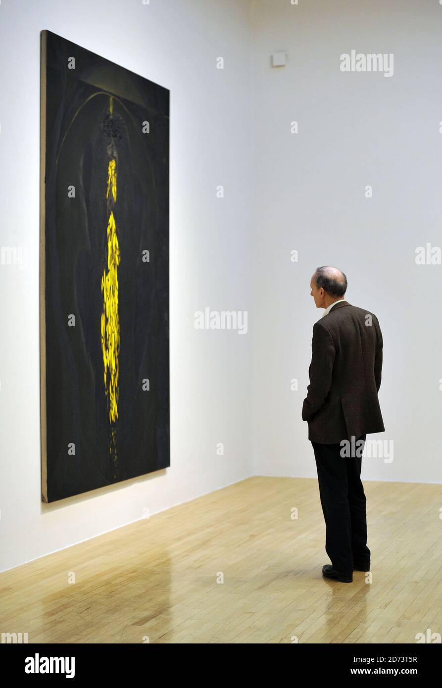 Visitors look at works by Chris Ofili on display at a new exhibition of ...