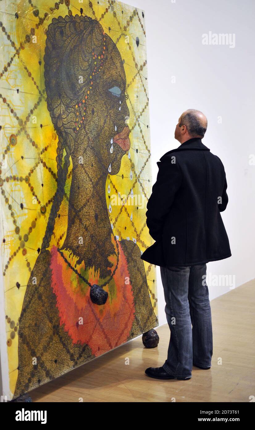 visitors-look-at-works-by-chris-ofili-on-display-at-a-new-exhibition-of