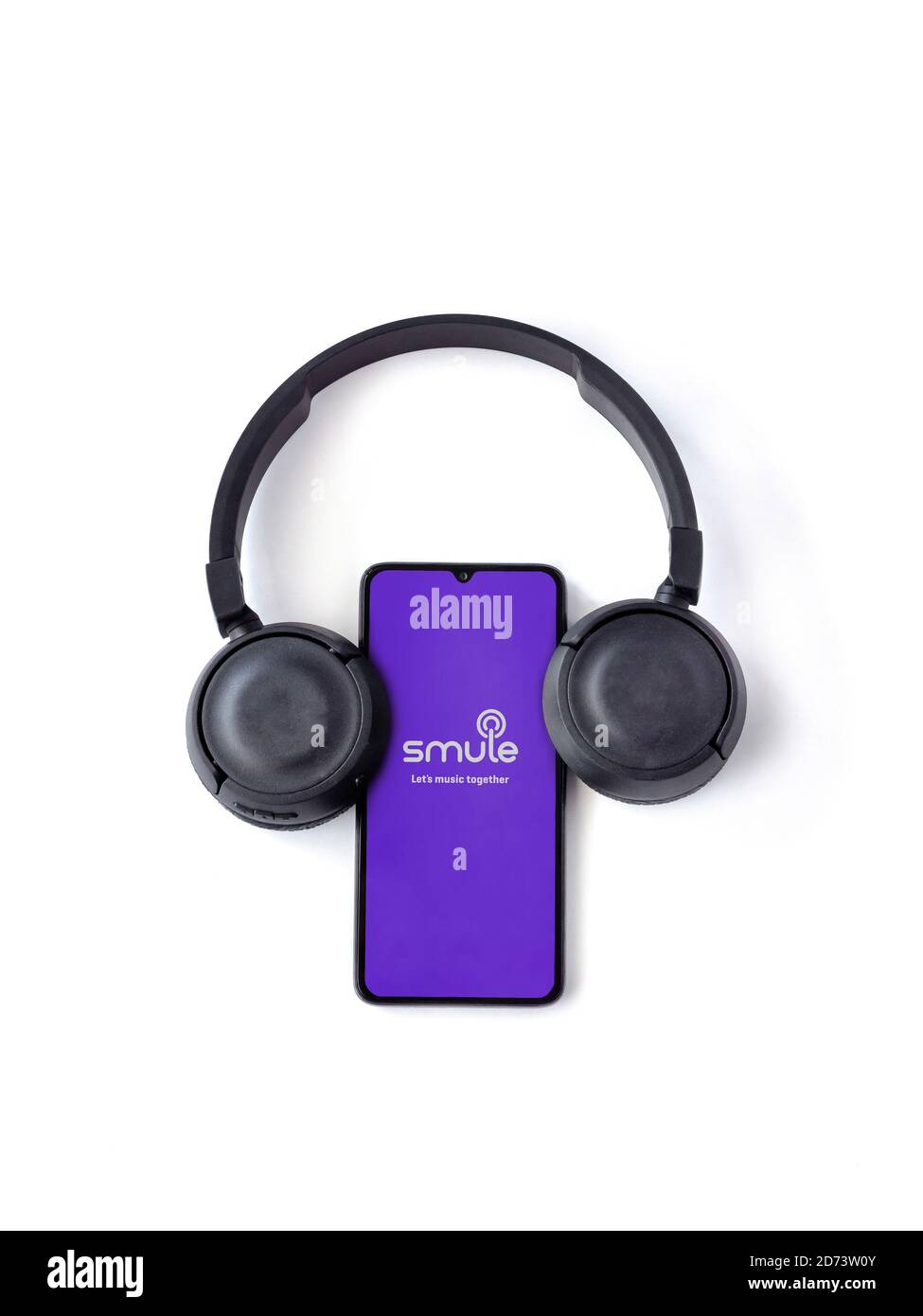Lod, Israel - July 8, 2020: Black mobile smartphone with Smule app launch  screen with logo and wireless headphones on a white background. Top view  fla Stock Photo - Alamy