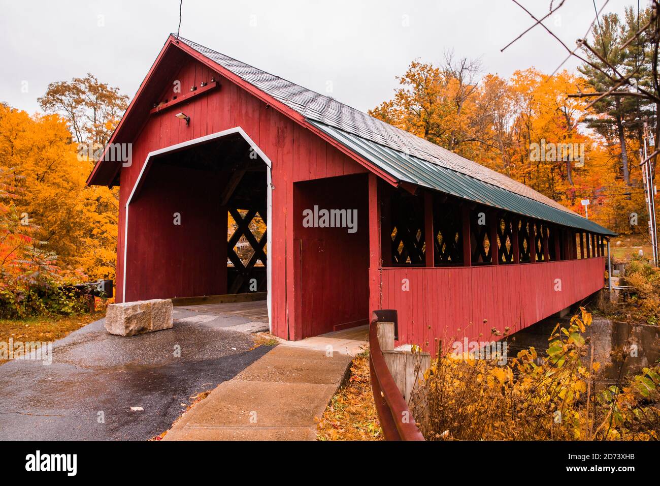 Beautiful Vermont covered bridge surrounded by colorful fall foliage. Stock Photo