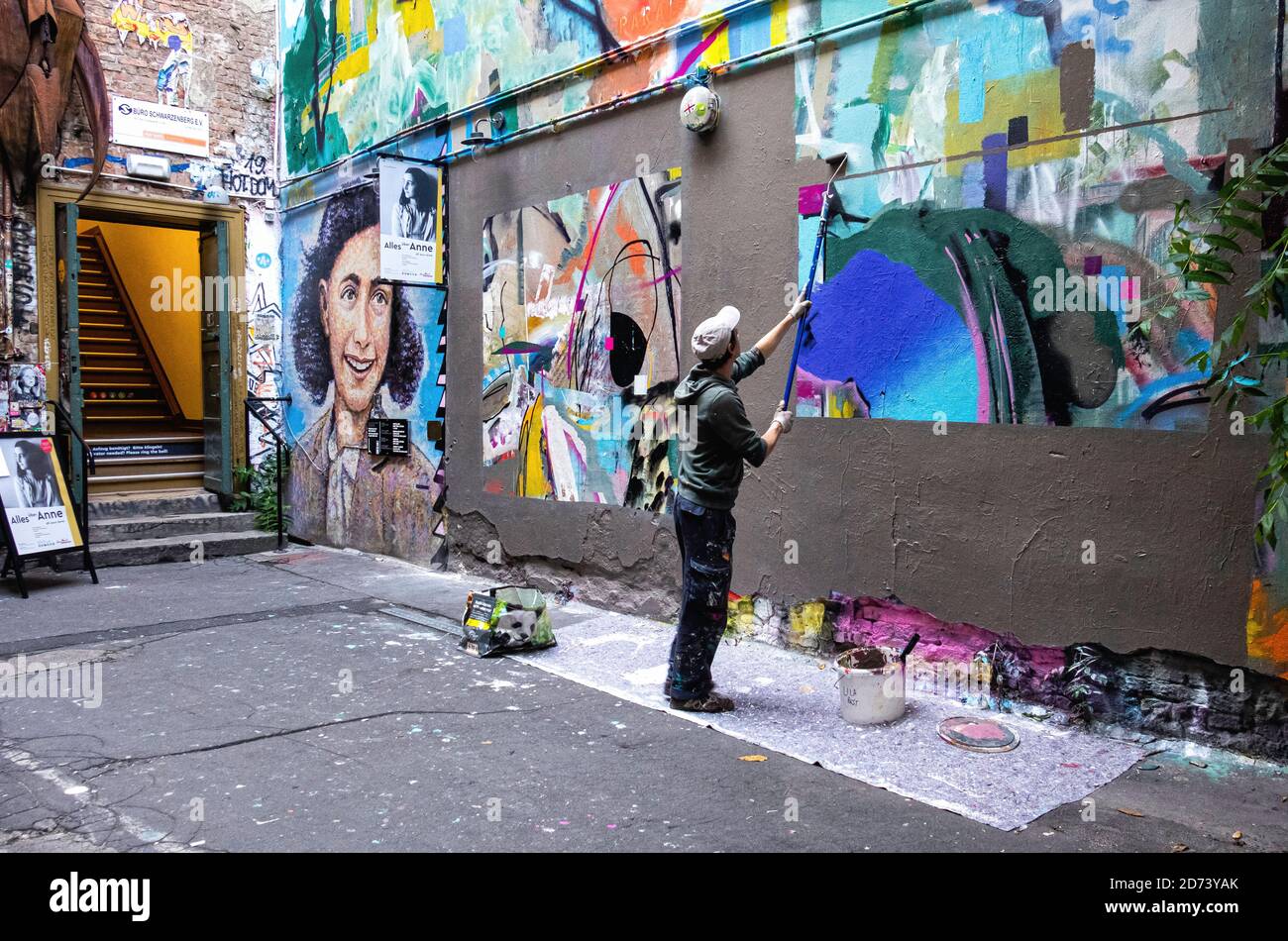 Mman painting over street art outside Anne Frank Museum at Haus Schwarzenberg, 39 Rosenthaler Strasse, Mitte, Berlin. Stock Photo