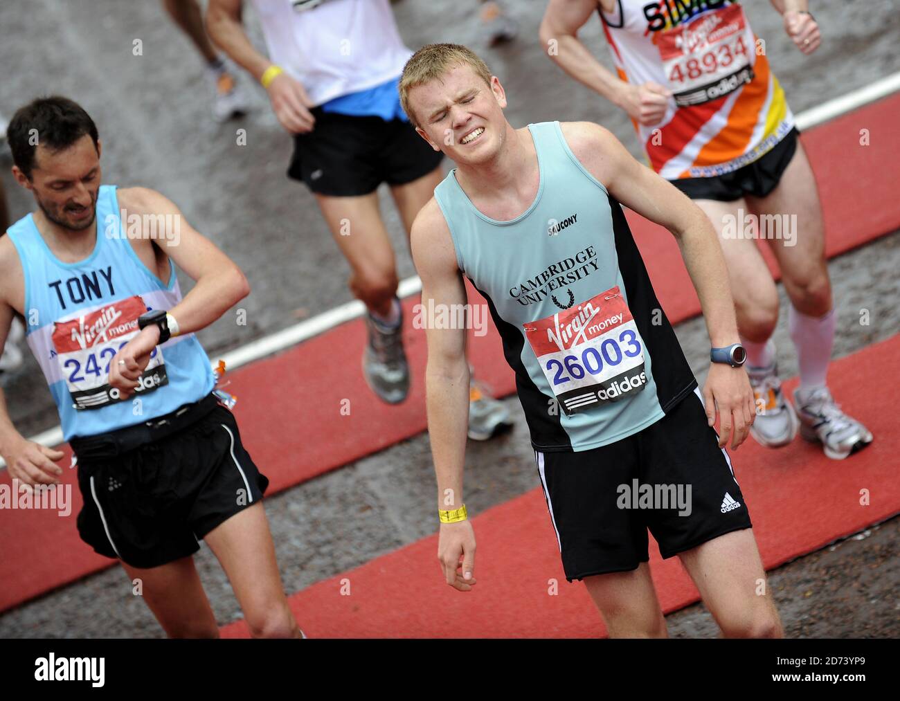 Runners struggle as they finish the 2010 London Marathon, on the Mall