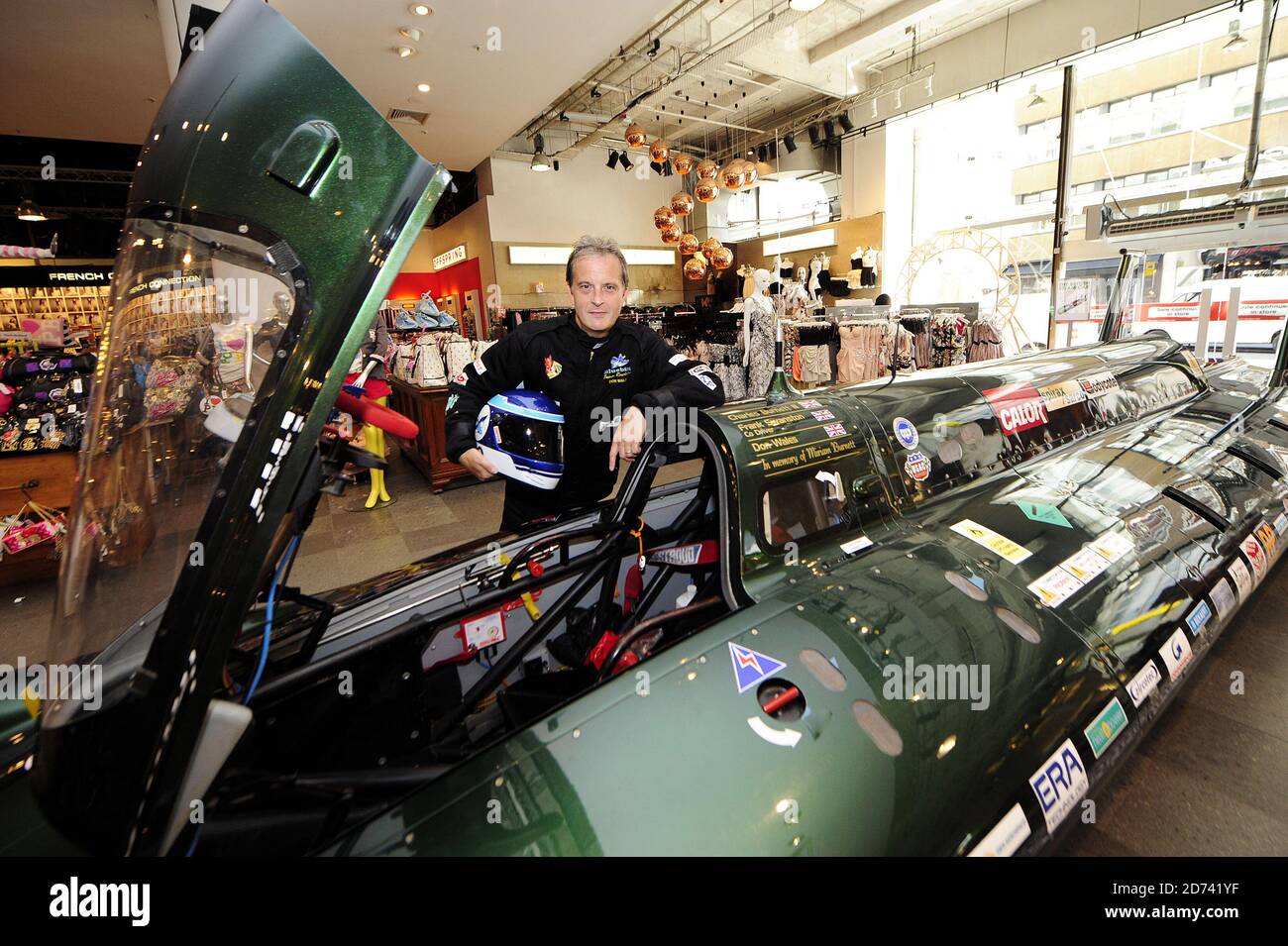 Driver Don Wales poses with the British Steam Car in Selfridge's store in central London. The car broke the land speed record for a steam-powered vehicle, reaching 139 mph in August 2009, and will be on display at Selfridge's all week.  Stock Photo