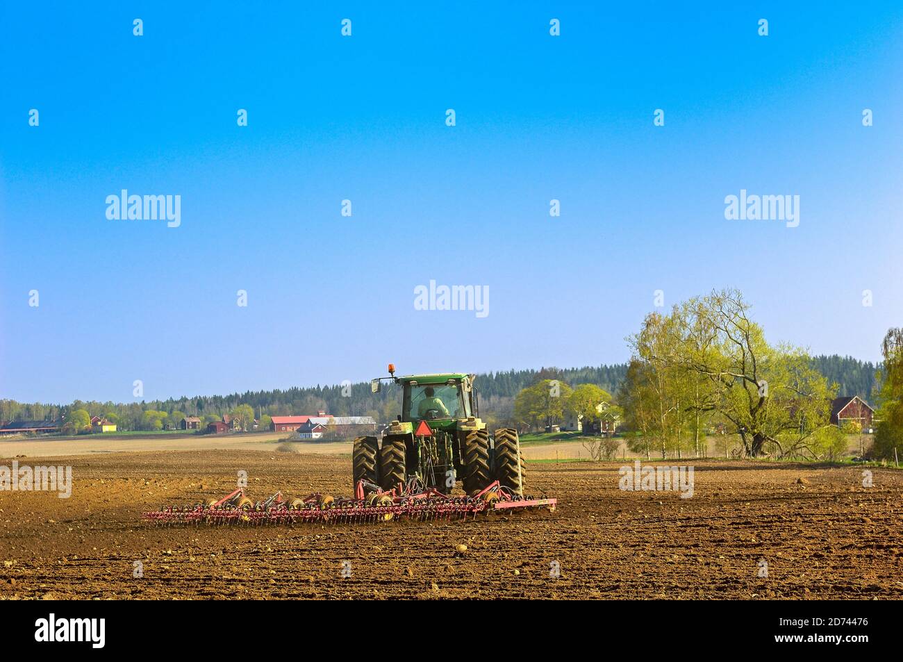 Farmer harrowing his field hires stock photography and images Alamy