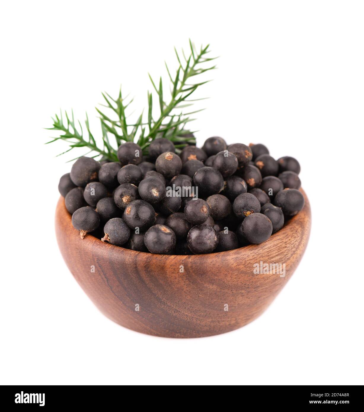 Dry juniper berries in wooden bowl, isolated on white background