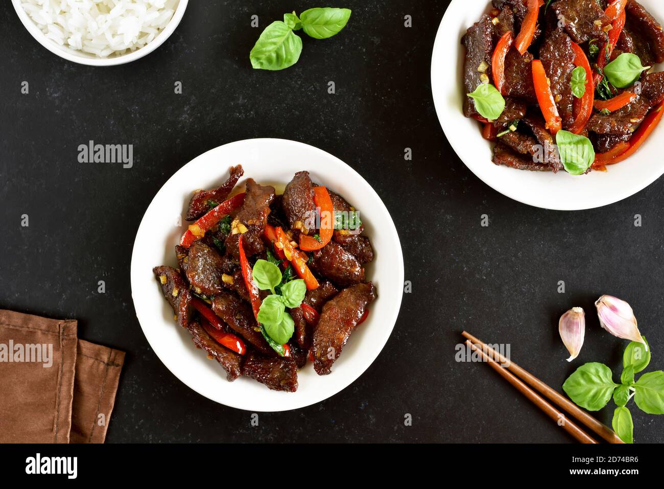 Thai beef stirfry with pepper and basil in bowl. Top view, flat lay