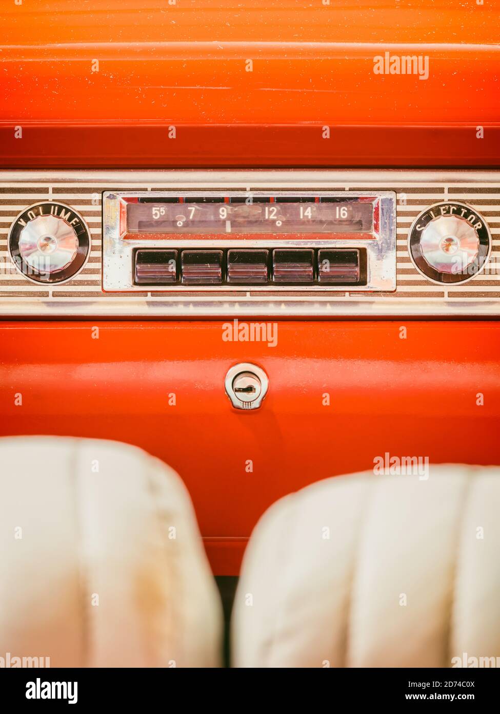 Old car radio inside an orange classic American car with chrome dashboard Stock Photo