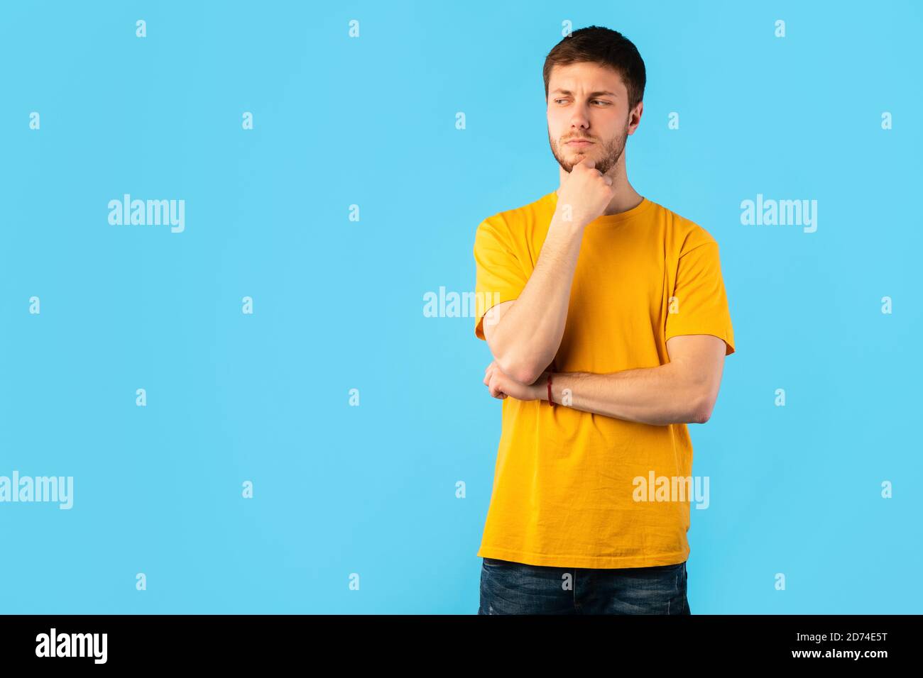 Pensive man thinking about question, touching chin Stock Photo - Alamy