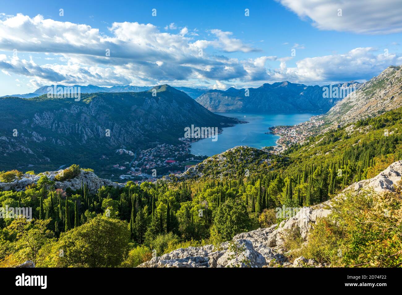 Sunset view to KotorBay from mountain serpentine road above the sky with clouds at sunset. Stock Photo