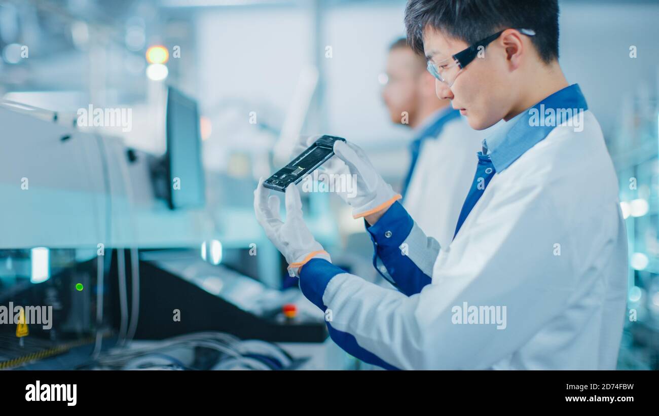 High Tech Quality Testing High tech quality control inspector hi-res stock photography and images ...