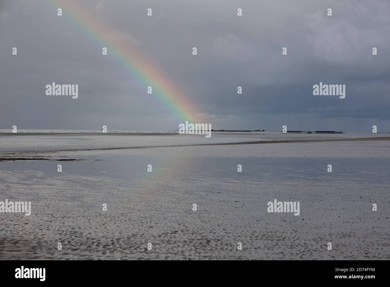 Rainbow between dark clouds hi-res stock photography and images - Alamy