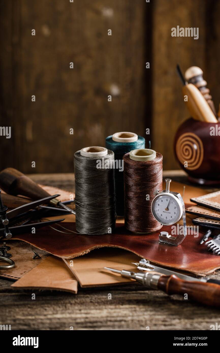 Leather craft tools on old wood table. Leather craft Stock