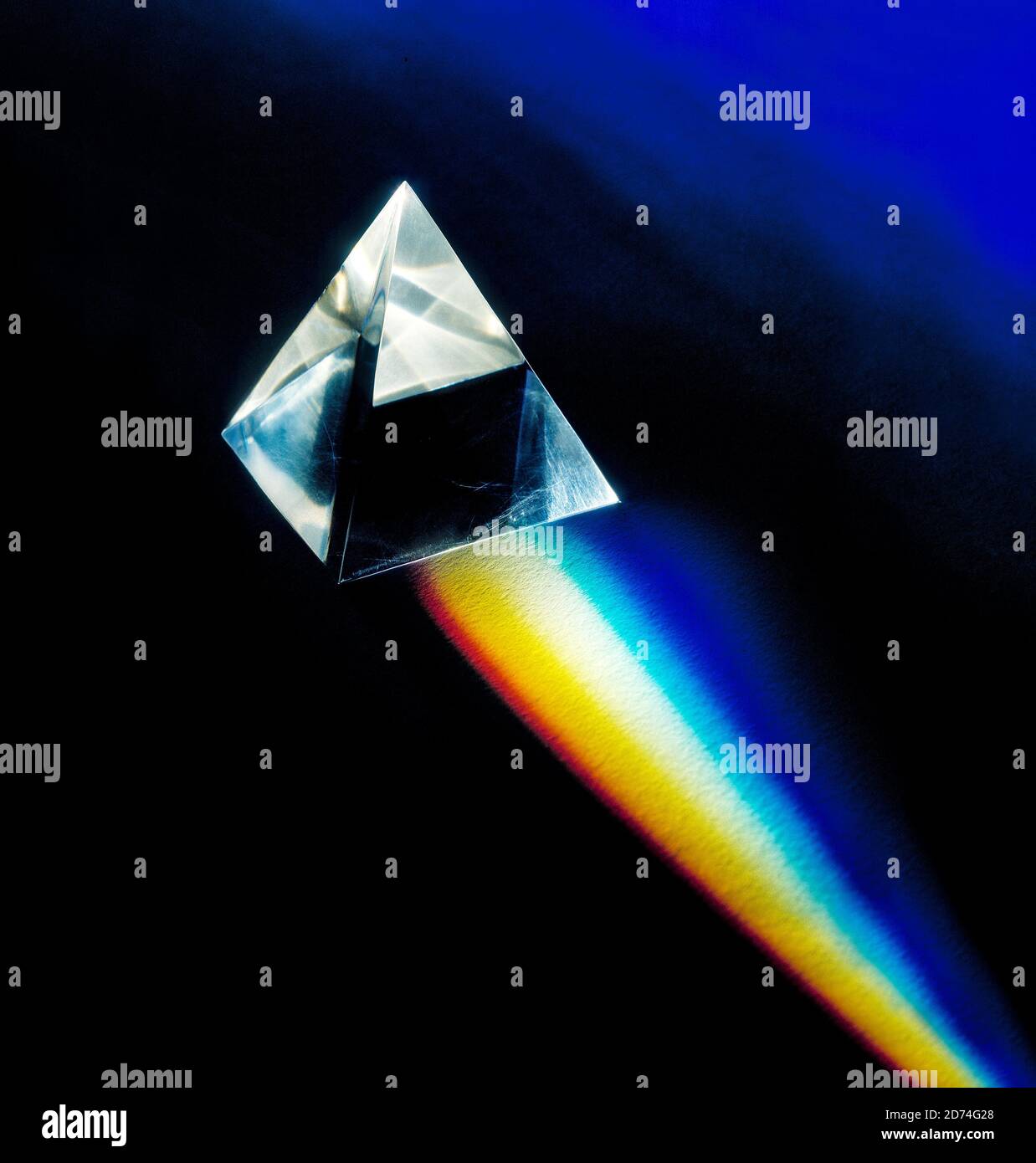 Prism on a black background with refracted white light split into the