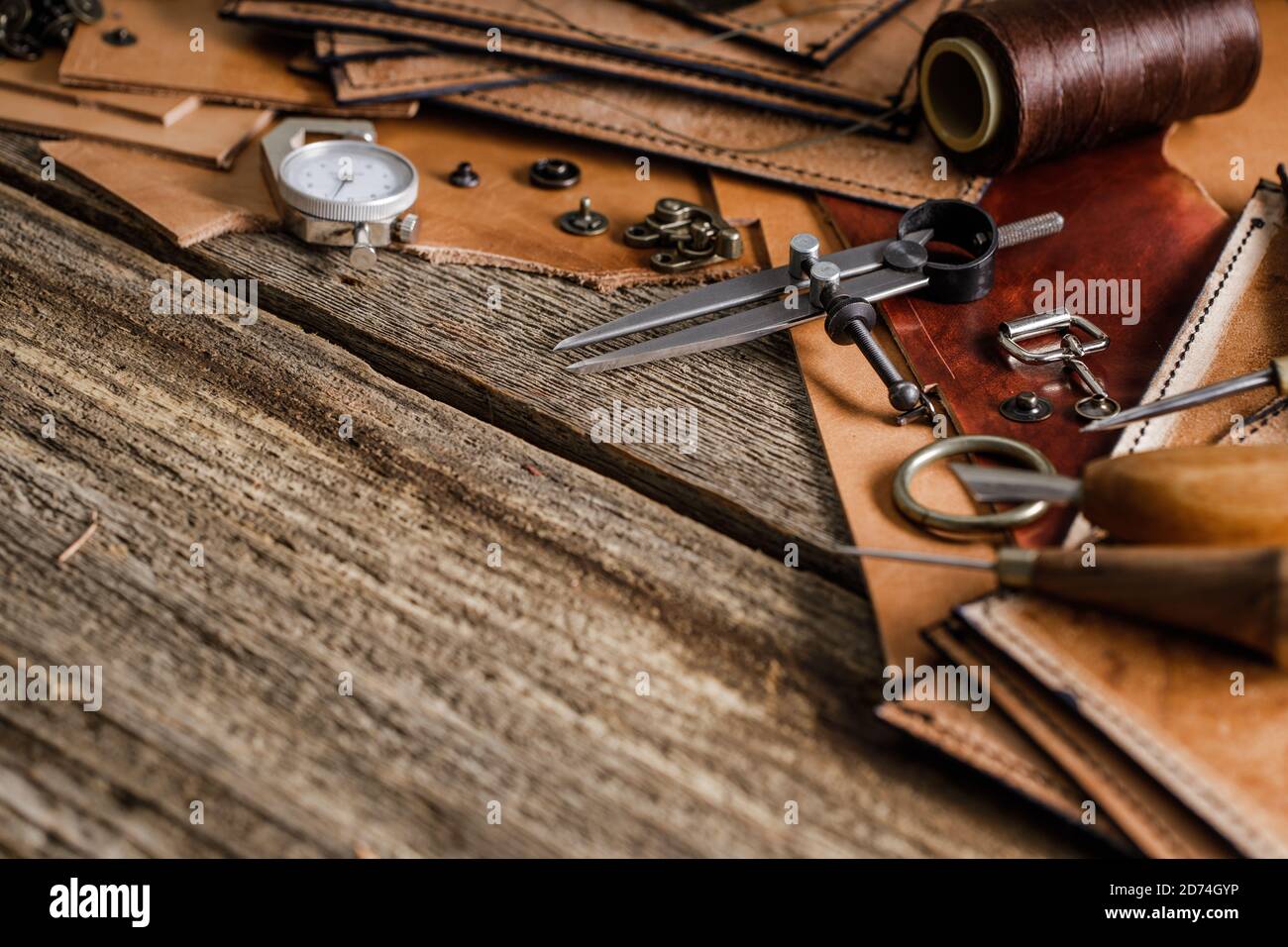 Leather craft tools on old wood table. Leather craft workshop Stock Photo -  Alamy