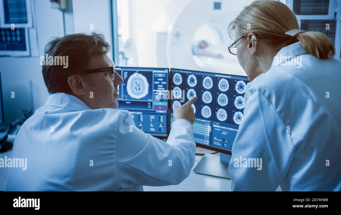 In Control Room Doctor and Radiologist Discuss Diagnosis while Watching ...