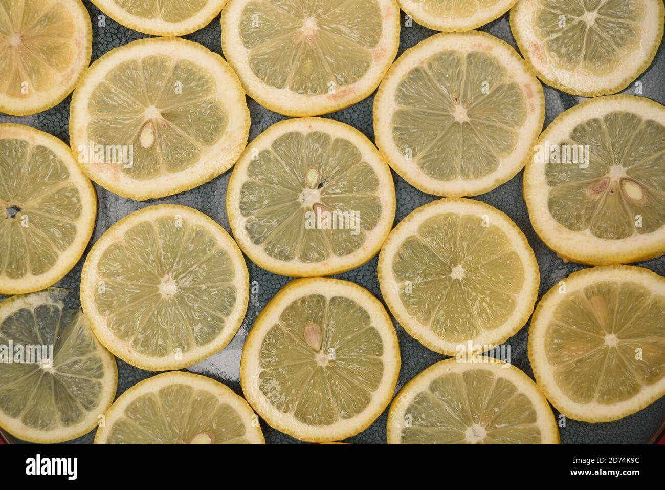 sliced of lemons on a blue plate Stock Photo