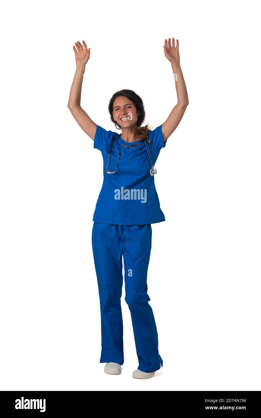 Portrait of happy smiling female nurse in blue uniform with raised arms isolated on white background full length studio portrait Stock Photo