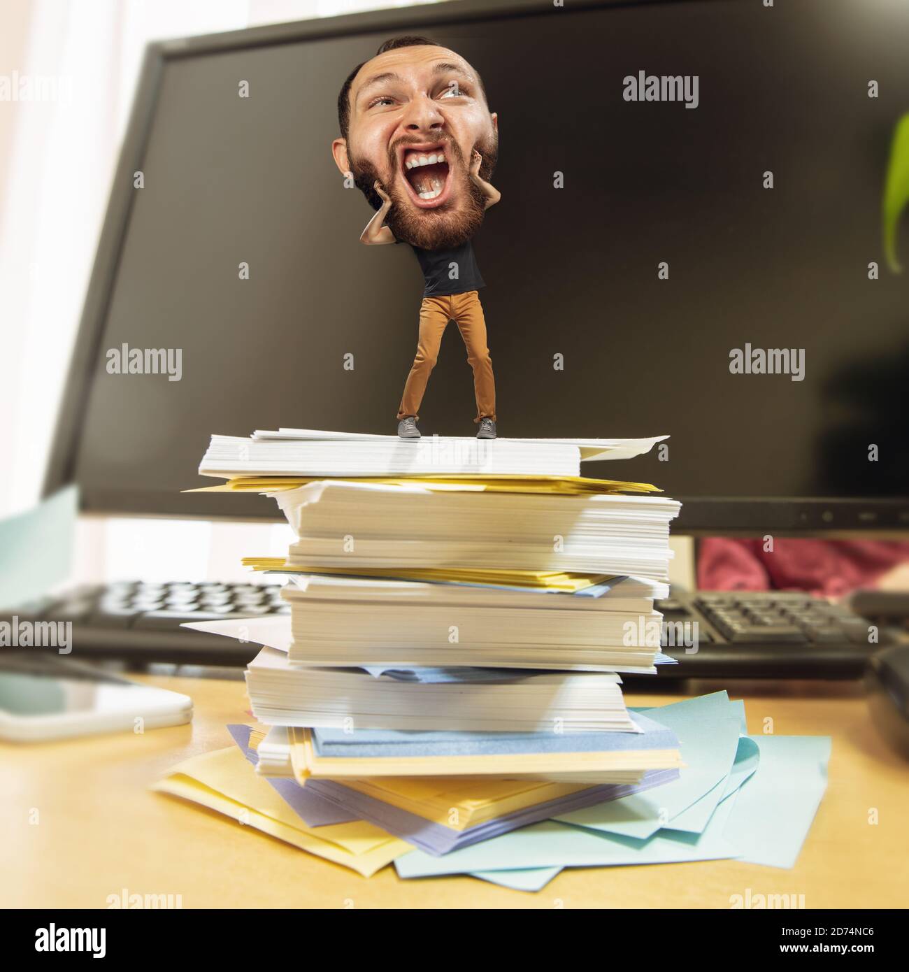 Screaming. Tired man, office worker holding his huge tired head, funny. Overworked caucasian man with little body and huge head looks stressed, shocked at big workplace. Concept of work, job, deadline. Stock Photo