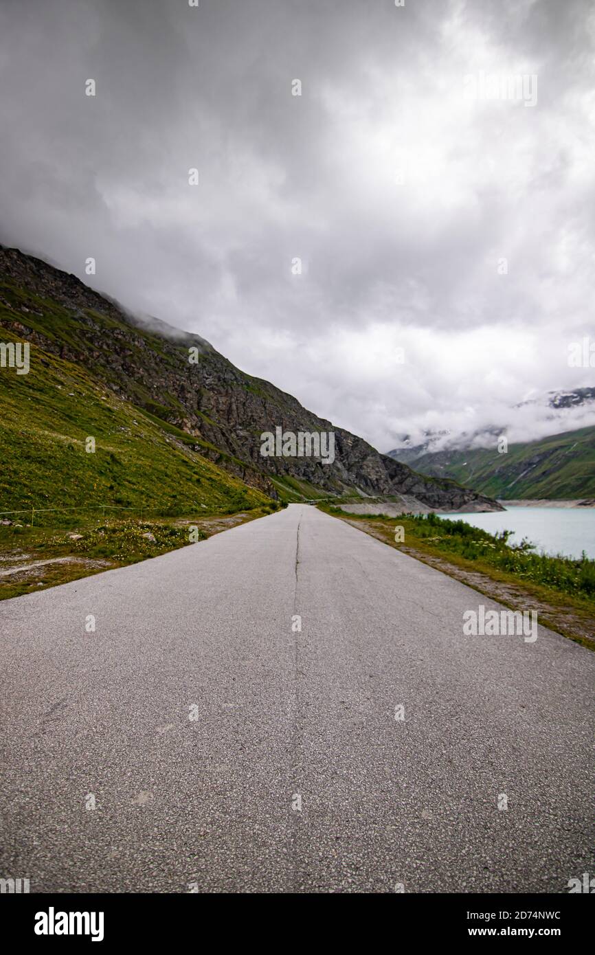 yellow coach of public transportation service. Busstop on top of Lac de Moiry in the Swiss Alps. At Grimentz Vallis, Switzerland. Stock Photo