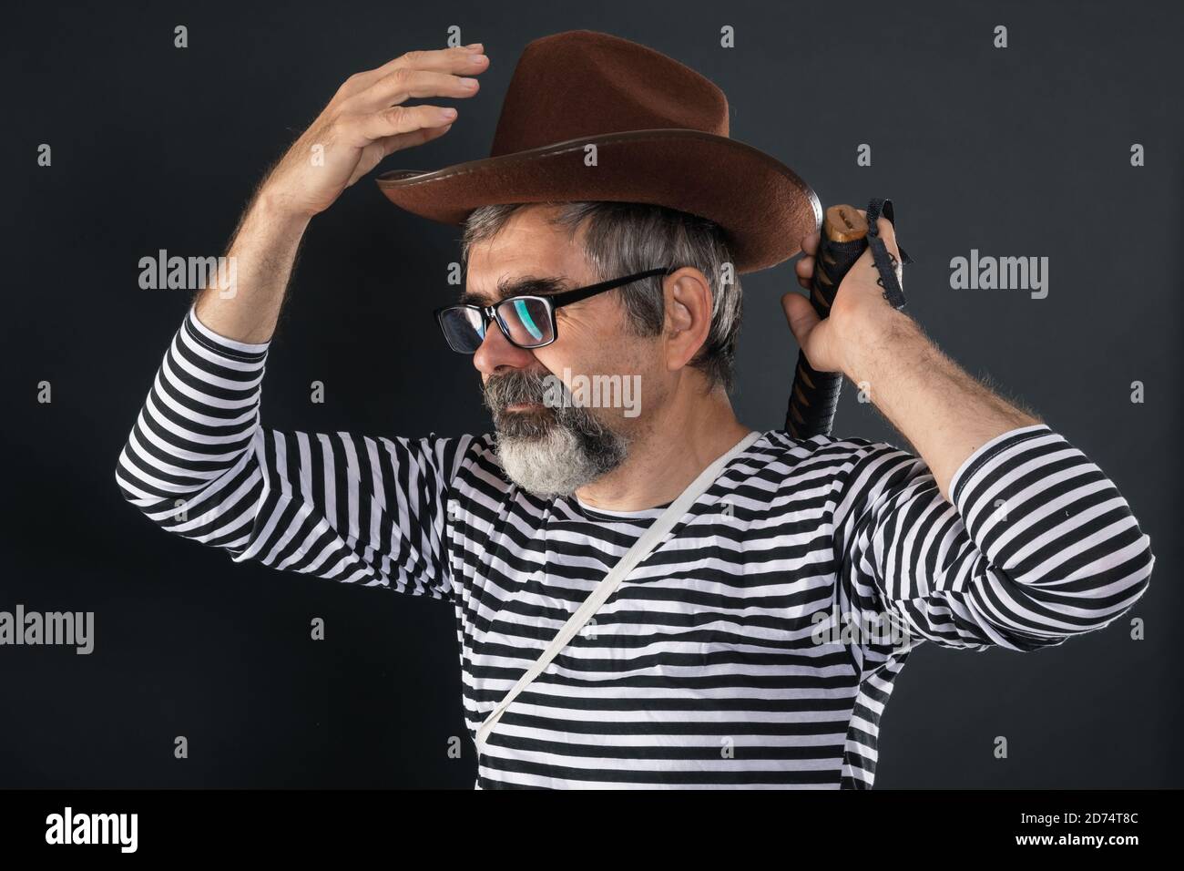 Elderly man fooling around and playing the role of a crazy pirate Stock Photo