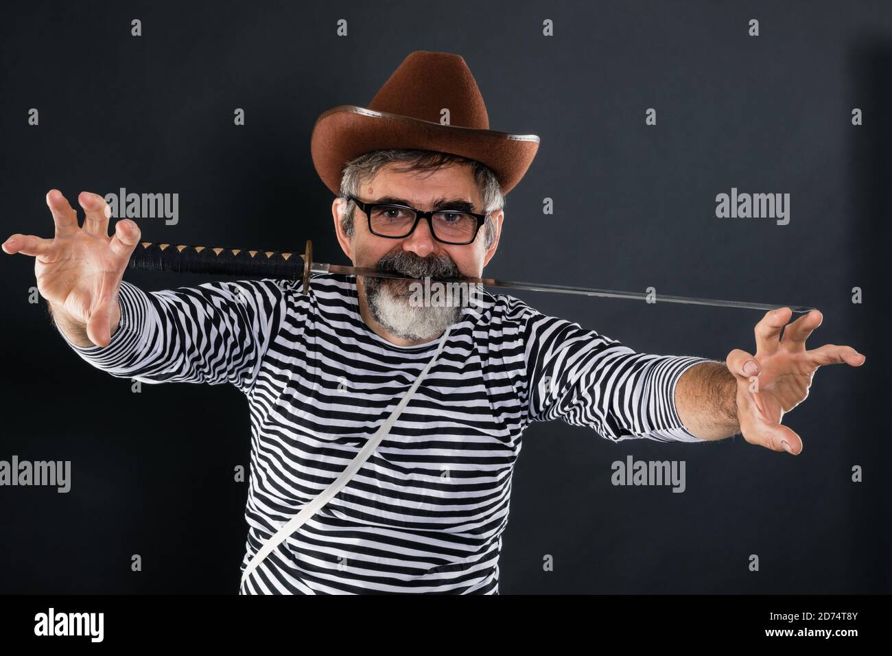 Elderly man fooling around and playing the role of a crazy pirate Stock Photo