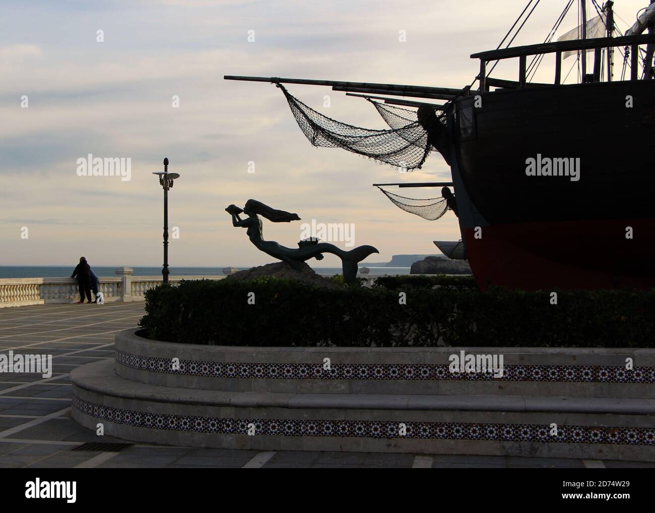 Mermaid sculpture in front of three replica ships which were sailed across the Atlantic Ocean in 1977 Santander Cantabria Spain Stock Photo