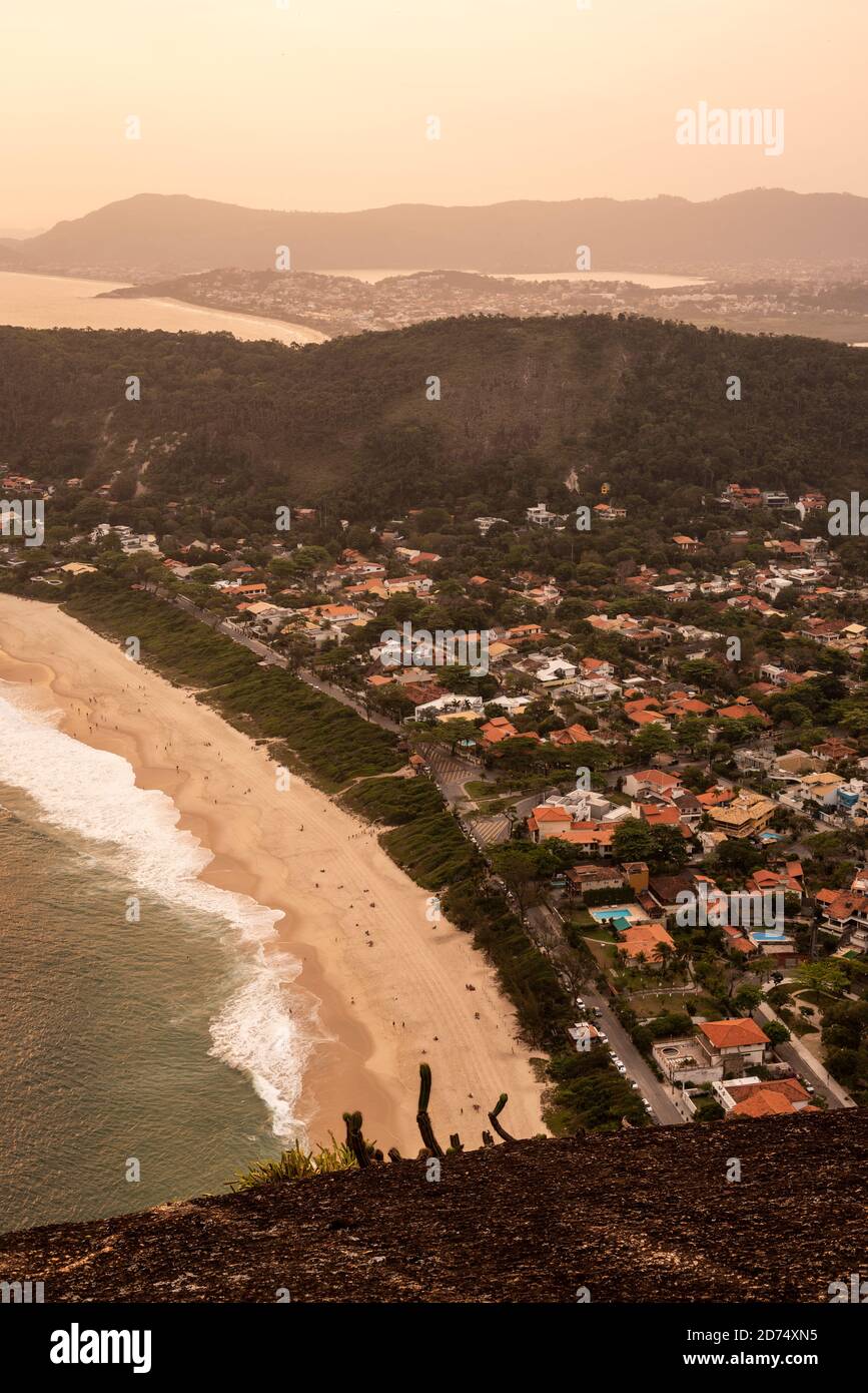 Beautiful sunset view from hill top to ocean beach of Itacoatiara, Rio de Janeiro, Brazil Stock Photo