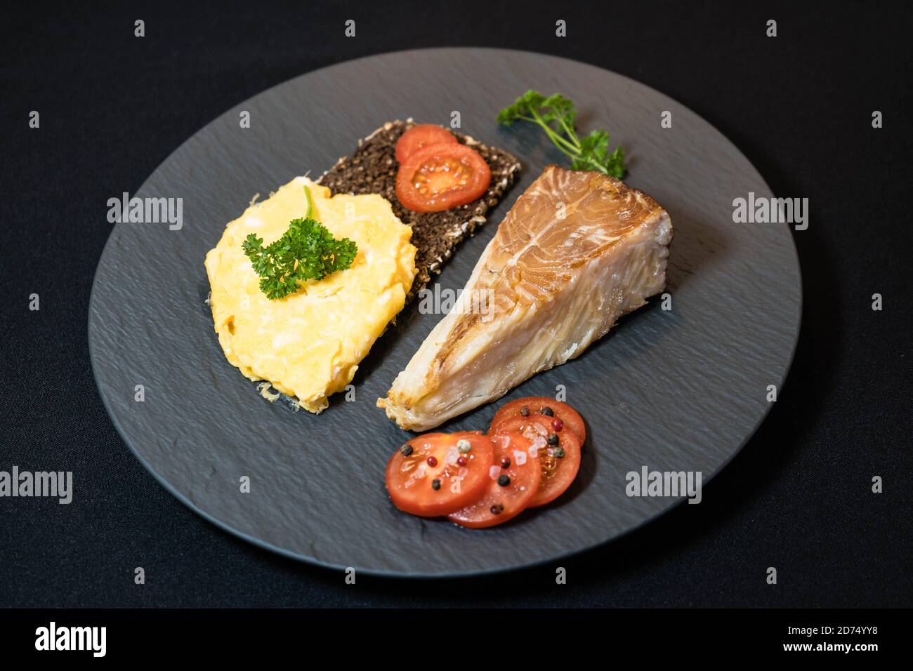smoked greenland halibut with tomato salad bread and eggs Stock Photo