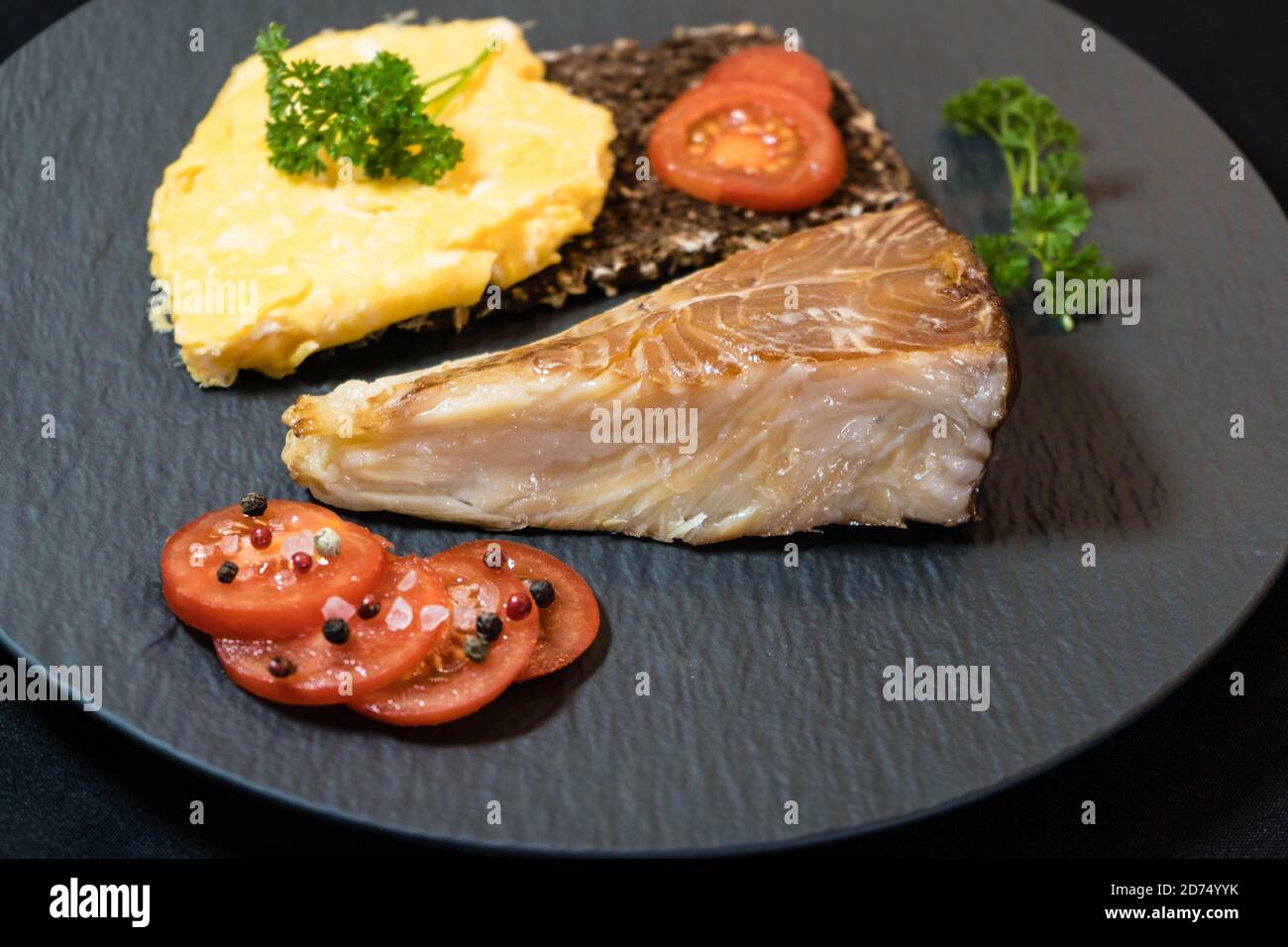 smoked greenland halibut with tomato salad bread and eggs Stock Photo