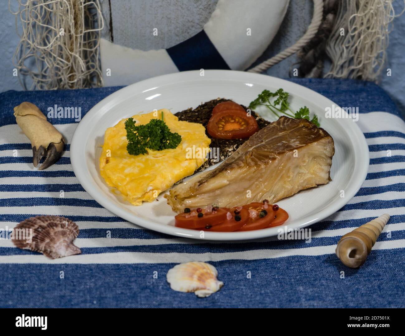 smoked greenland halibut with tomato salad bread and eggs Stock Photo