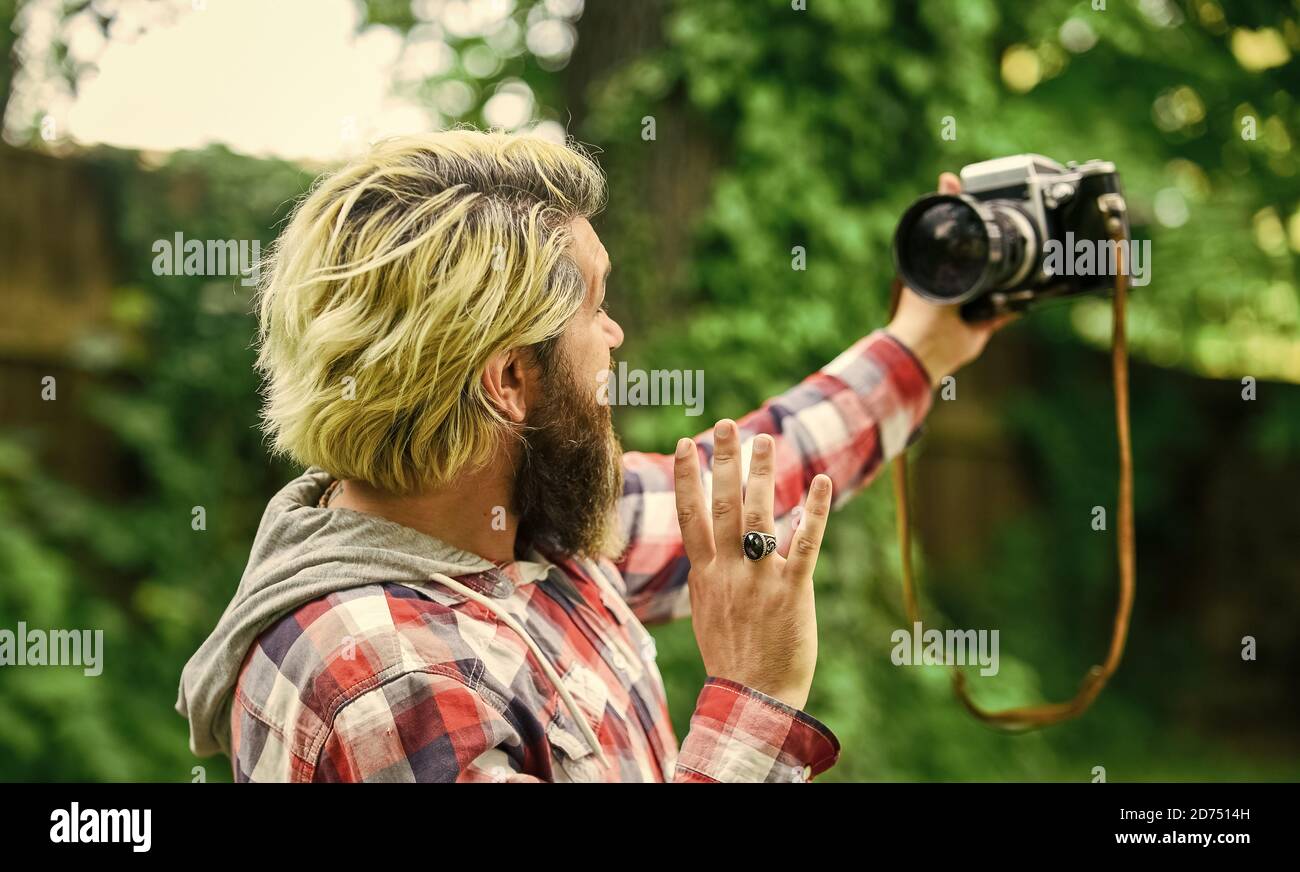 capture these memories. SLR camera. hipster man with beard use professional camera. selfie time. photographer hold retro camera. journalist is my career. reporter make photo. vintage camera. Stock Photo