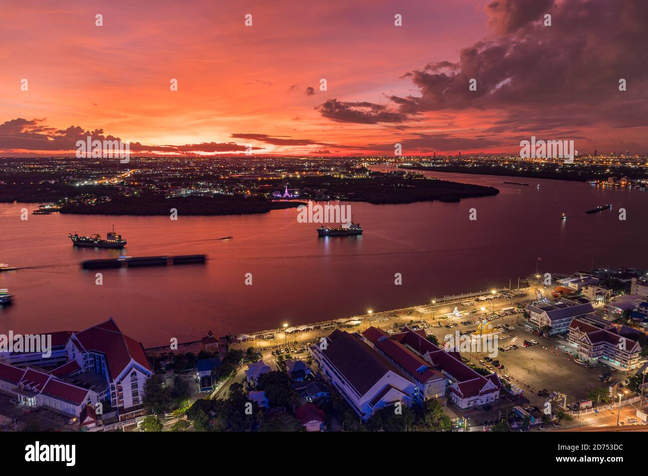 Bird's eye view of Samut Prakan, Thailand. Sunset over the Chao Phraya River, orange sky. Stock Photo