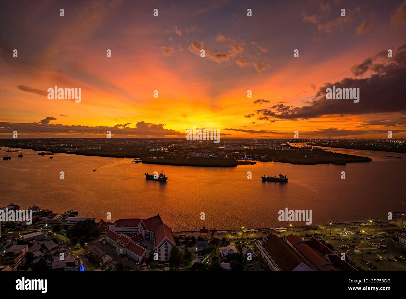 Bird's eye view of Samut Prakan, Thailand. Sunset over the Chao Phraya River, orange sky. Stock Photo