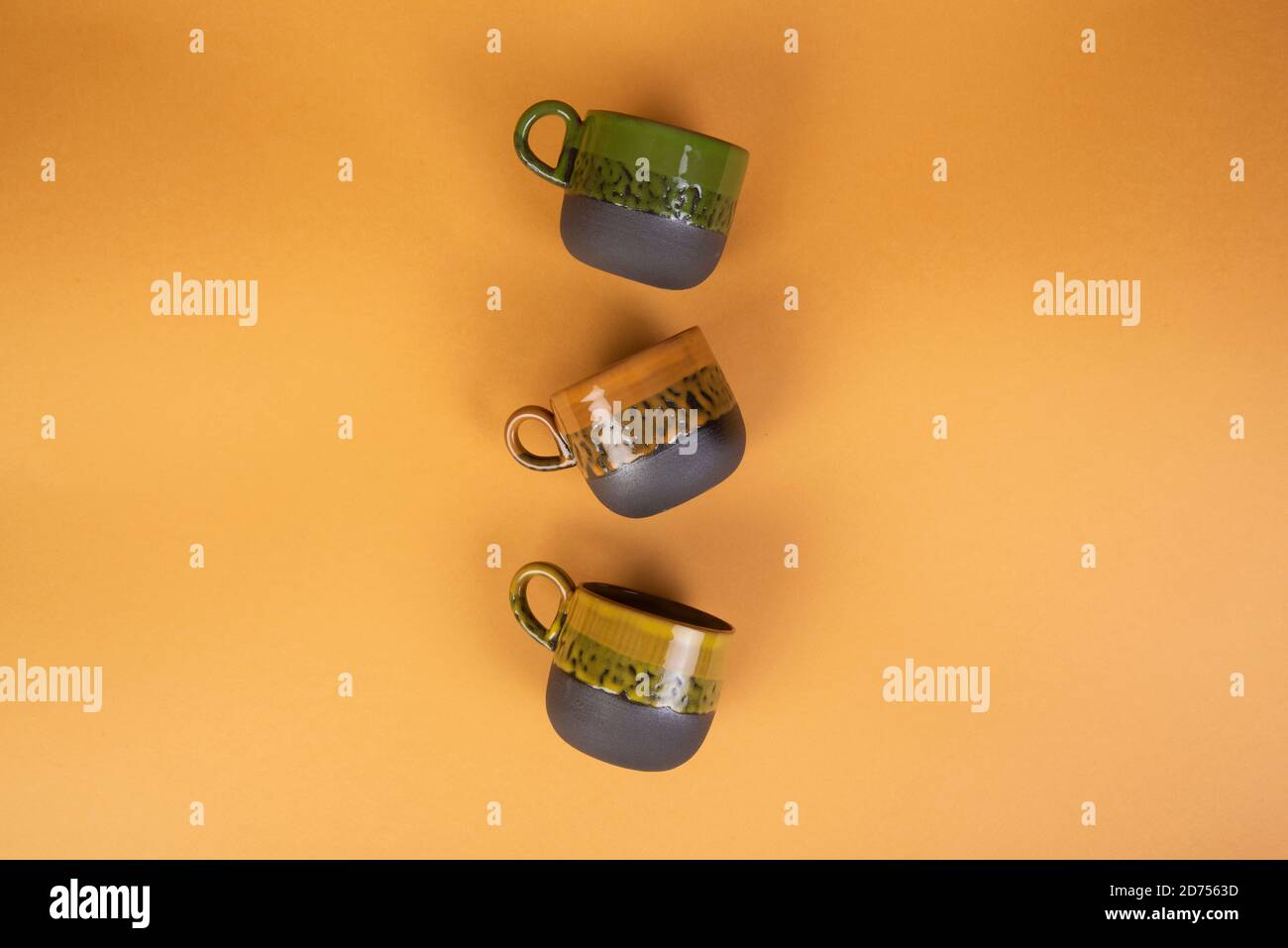 porcelain coffee cups on yellow background Stock Photo