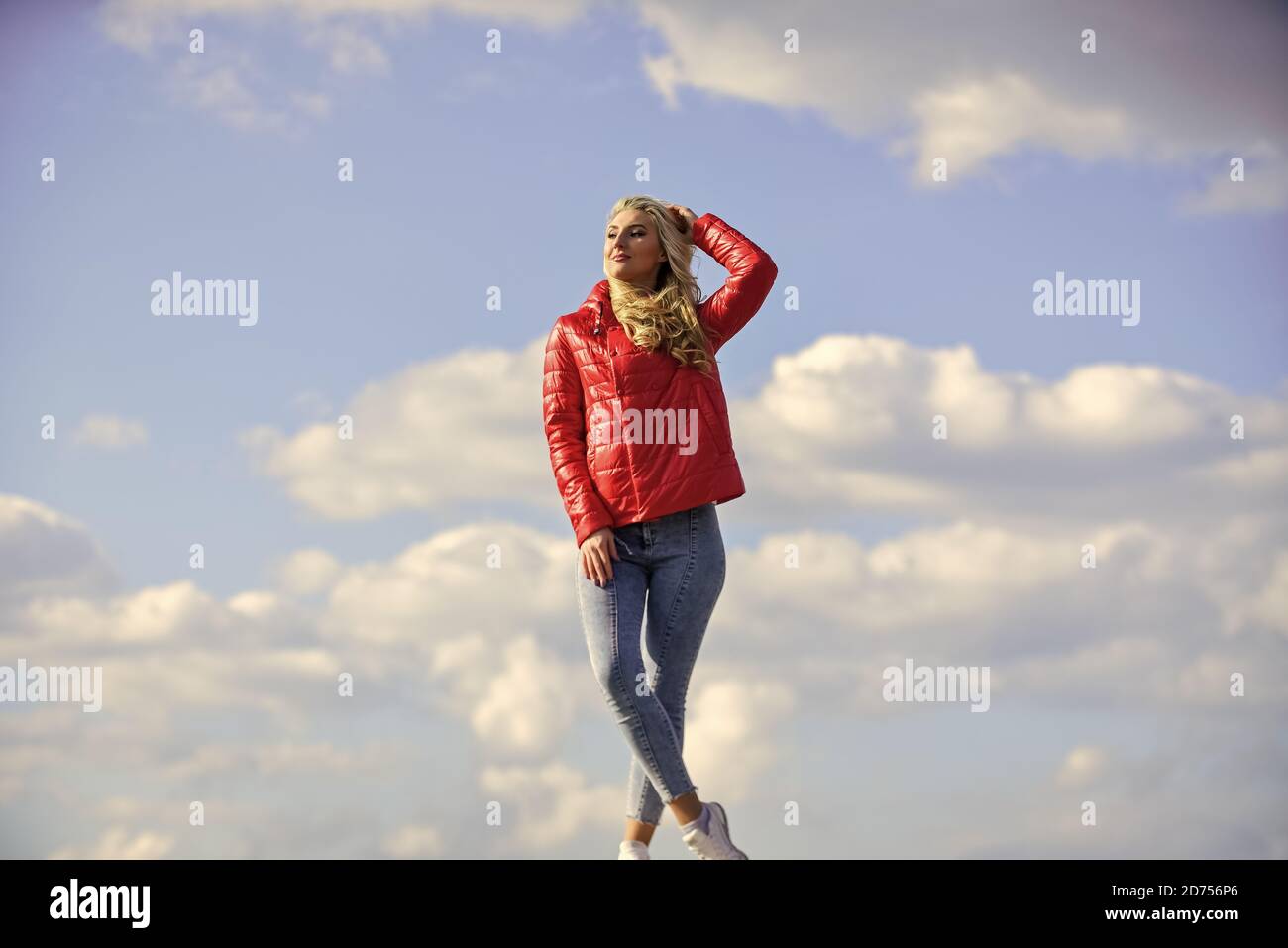 Young and beautiful. woman in model pose outdoors. feel free. woman enjoying weather outdoors. Freedom and expectation. Beauty and fashion, look. concept of loneliness. woman on blue sky background. Stock Photo