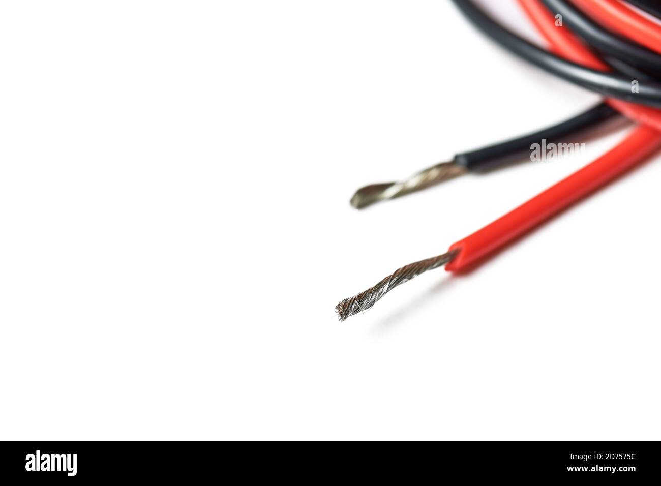 Isolated aluminum bare wires of electric cable. Red and black wires