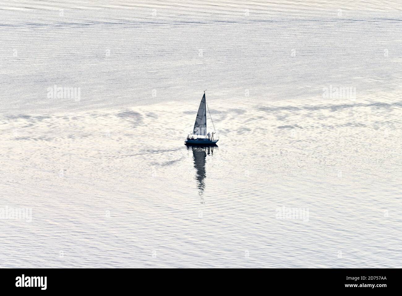 Yacht With White Sail Sails In Bay At Dusk Yacht Gliding At Sea Beautiful Minimalistic Waterscape Stock Photo Alamy
