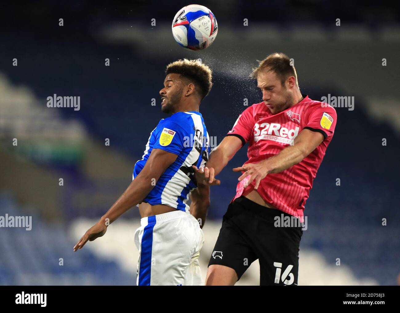 Huddersfield Town's Fraizer Campbell (left) and Derby County's Matt Clarke battle for the ball during the Sky Bet Championship match at The John Smith's Stadium, Huddersfield. Stock Photo