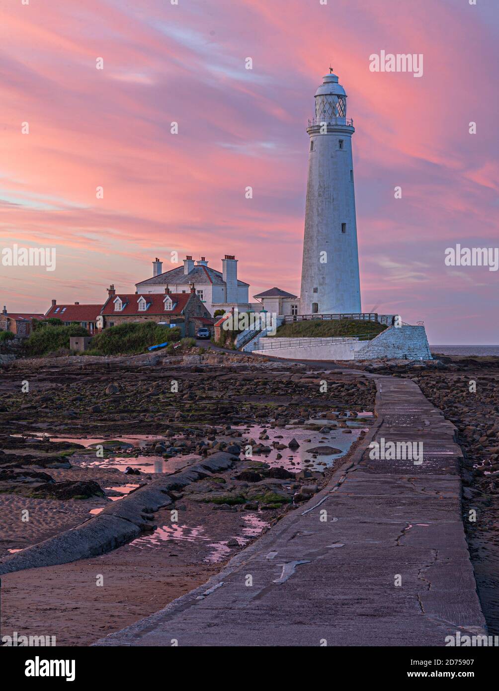 A glorious sunset lighting up the clouds over St Mary's Lighthouse at Whitley Bay on the Northumberland coast, England, UK Stock Photo